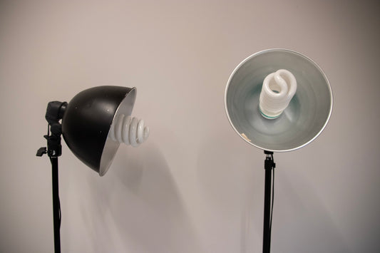 Two studio lights with fluorescent bulbs facing left.