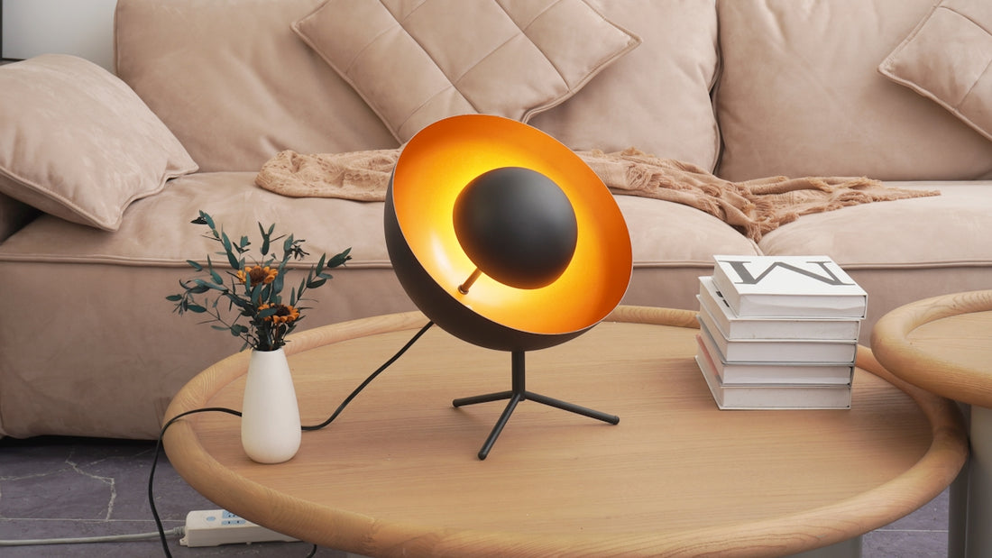 Modern black lamp with golden interior on coffee table.
