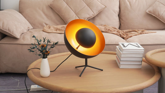 Modern black lamp with golden interior on coffee table.